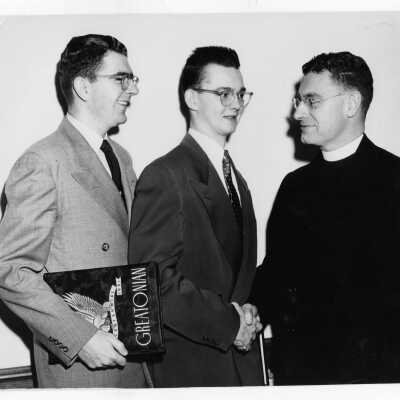Two students from Villiger Debating Society, Joseph T. English and Frederick W. Floyd, talking with Edward G. Jacklin, S.J.