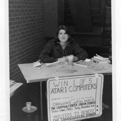 Student selling raffle tickets to win Atari computers to raise funds for Thanksgiving dinner for senior citizens, a community service/outreach project.