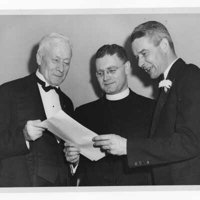 Edward G. Jacklin, S.J., with toastmaster, John J. Sullivan (class of 1896) and speaker during banquet held in Field House as part of centennial anniversary celebration.