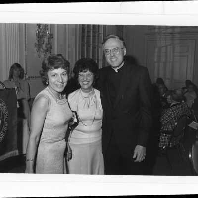 Donald I. MacLean, S.J.,with Teresa Scaperotto of the Bellarmine Guild and another individual at alumni awards dinner, c. 1980.