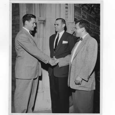 Alumni officer, William Ariano, greeting two alumni members, June 2, 1955.