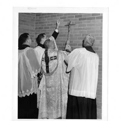 Bellarmine dedication with J. Joseph Bluett, S.J. and Egidio Vagnozzi placing cross on interior wall.