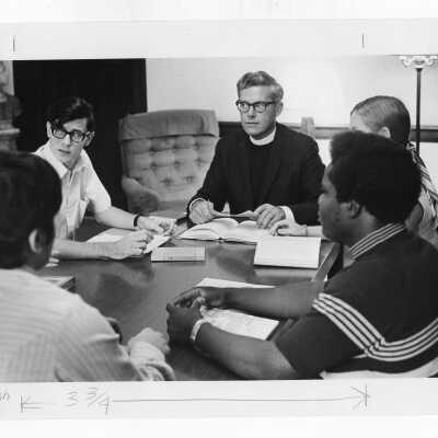 Jerome Coll, S.J. having discussion with Honors Program students in Drexel Library, c. 1973.
