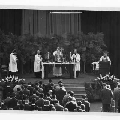 William F. Maloney, S.J., and others during Mass of the Holy Spirit in Field House, c. 1962.