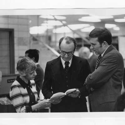 Thomas P. Melady with Josephine Savaro and another individual in library.