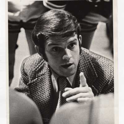 Men's Basketball Coach Jimmy Lynam at game talking to players