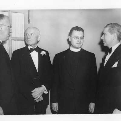 Edward G. Jacklin, S.J., with three guests during banquet held in Field House as part of centennial anniversary celebration.