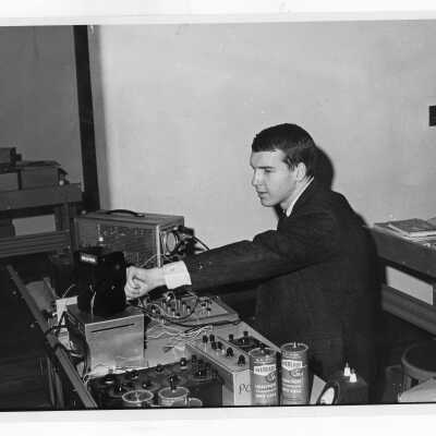 View of student in Radio Club (Station WSJR?) working with equipment.