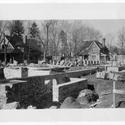 Foundation and construction for Jesuit Faculty Residence with carriage house and Loyola cottage in background.
