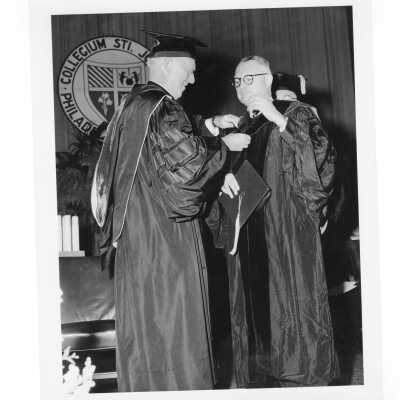 J. Joseph Bluett, S.J. conferring honorary degree to Gerald Flood during 1961 graduation/commencement.