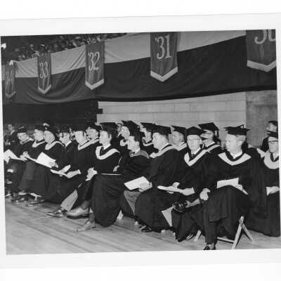 View of faculty members attending 1961 graduation/commencement ceremony in Field House.
