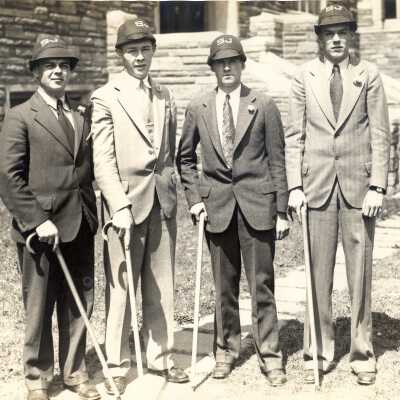 Four students participating in cap and cane walk in Quadrangle. The walk was the opening feature of Junior Week activities.