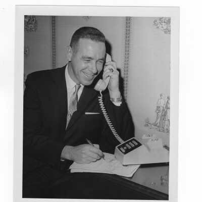 Bernard Drueding, chairman of annual giving campaign of alumni association, talking on telephone, c. 1966.