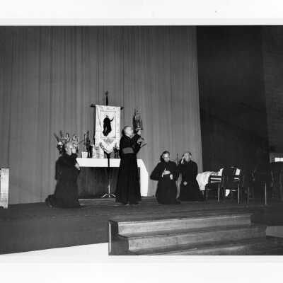 Academic Convocation on March 22, 1956 for the Fourth Centenary of Death of Saint Ignatius Loyola. Archbishop John O'Hara gives blessing to J. Joseph Bluett, S.J., Fr. James Mortimer, Joseph McNamara, S.J., and congregation in Field House after Mass.