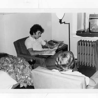 Students studying and watching television in Jordan Hall student residence dormitory room.