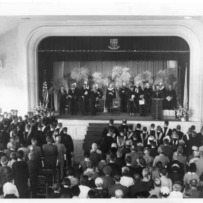 View of stage and audience in Flanigan Auditorium during academic convocation, October 4, 1959, the occasion of the first presentation of the Father Greaton Chalice.
