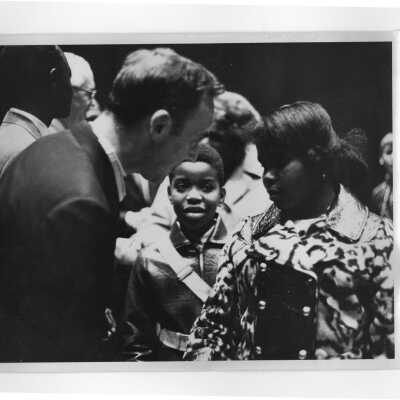 Terrence Toland, S.J., greeting children at reception for Francois Tombalbaye, President of Chad, following convocation, October 26, 1970.