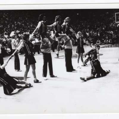 Men and women cheerleaders in pyramid.