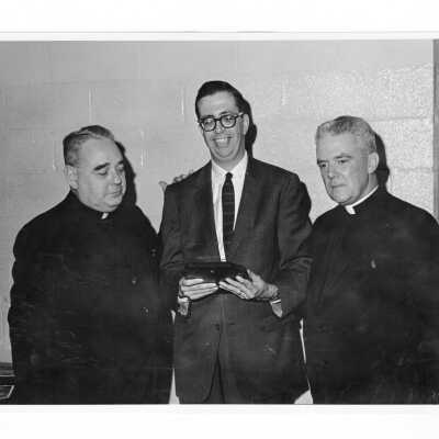 Frank Olley, director of Cap & Bells and professor of English, with Father Barr (?) and another priest, c. 1965.