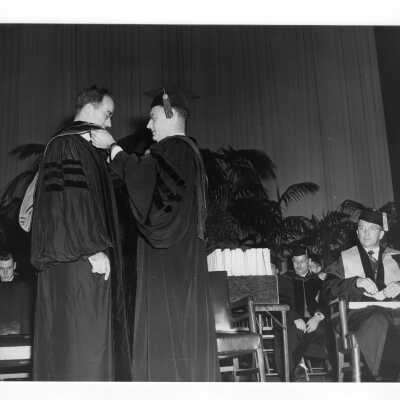 Edward G. Jacklin, S.J. bestowing honorary degree on Francis C. Nash during 1952 graduation/commencement ceremony.