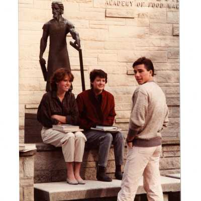Students sitting near statue of Saint Joseph the Worker in front of Villiger (later Post) Academy of Food Marketing.