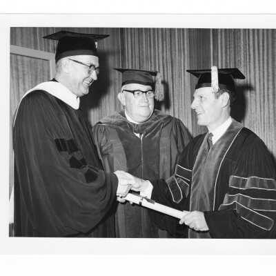 William F. Maloney, S.J., with John A. McCormick, M.D., Board of Lay Trustees, and honorary degree recipient, William F. Kellow, M.D. during September 1967 graduation/commencement.