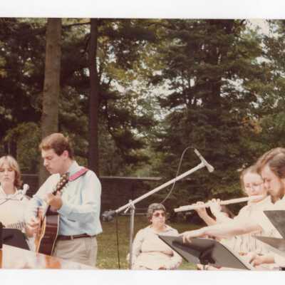 Students playing guitar and flute at dedication of Sourin Residence Center.