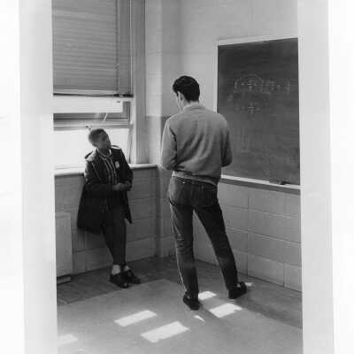 Student tutoring child at Rhoads Public School as part of community service/outreach project. (Part of Peace and Human Development Program?)
