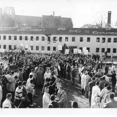 Student demonstration at Cardboard College also known as Barbelin Annex with sign on roof, "Help stamp out cardboard colleges!"