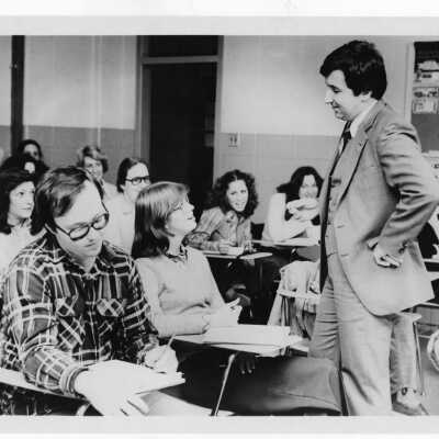 Students talking with professor during class.
