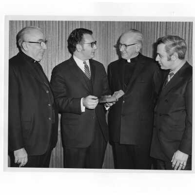 Rabbi Marc Tanenbaum, Cardinal John Krol, Bishop John Graham, and Edward H. Rosen (?) examining ancient book during Third Institute on Catholic -Jewish Relations, March 2, 1971.