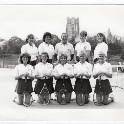 Group photo of women's tennis team with Coach Al Laveson.