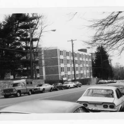 View of cars parked on Cardinal Avenue with Sourin Residence Center in background.
