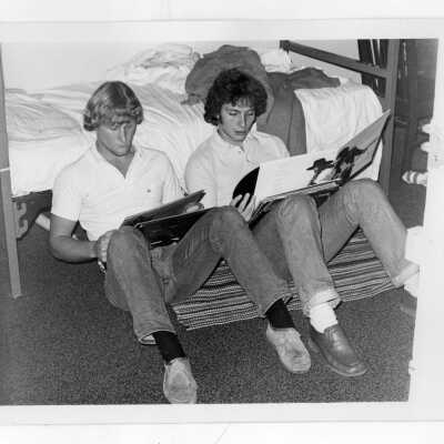 Two students looking at record albums in Jordan Hall student residence dormitory room.