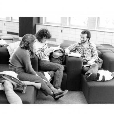 Three students in group discussion in lounge chairs in Drexel Library.