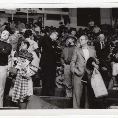 Spectators at basketball game, including Donald I. MacLean, S.J. at Palestra?