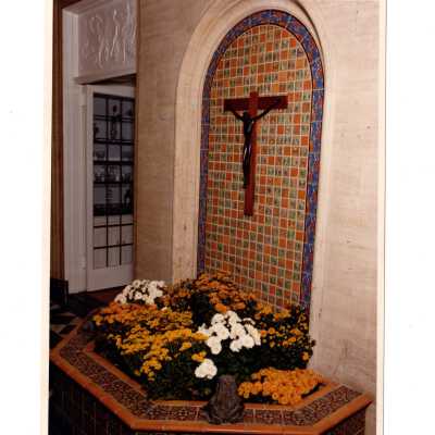 View of tiled fountain and chrysanthemums in sun porch in Regis Hall.