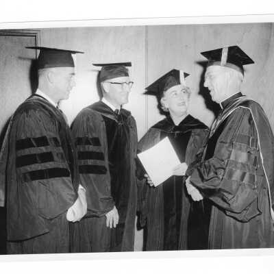 J. Joseph Bluett, S.J., with Michael Boland (Registrar) Albert Nesbitt (Board of Trustees), and the Honorable Kathryn Granahan, October 1959 graduation/commencement.