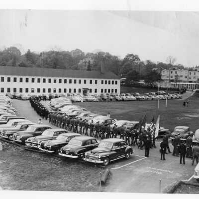 Procession of Air Force ROTC in front of cardboard college to academic convocation as part of centennial celebration, October 28, 1951.