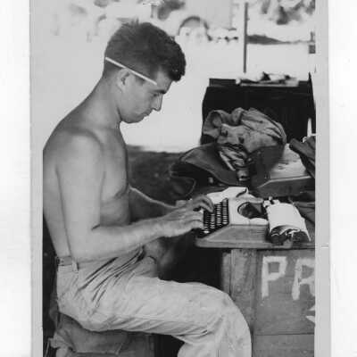 Cyril O'Brien (class of 1942) shown at typewriter as Marine Corps combat correspondent during World War II.