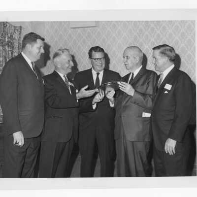 Charles A. Waters holding Law Alumni Award with others watching, November 28, 1967.