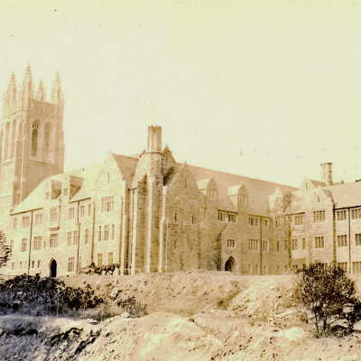 Exterior view of southern façade of Barbelin building near end of construction with two horses pulling supply wagon.