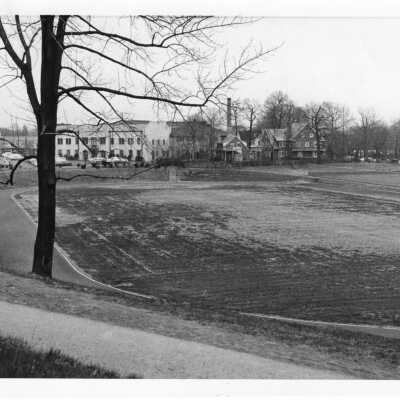 View of Finnesey Field with Field House and parking lot in background.