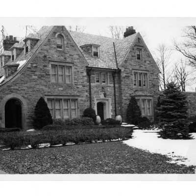 View of front of Regis Hall with snow on ground.
