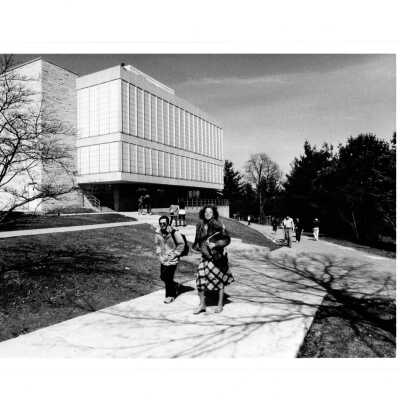 Exterior side view of new wing or addition to Drexel Library with students walking.