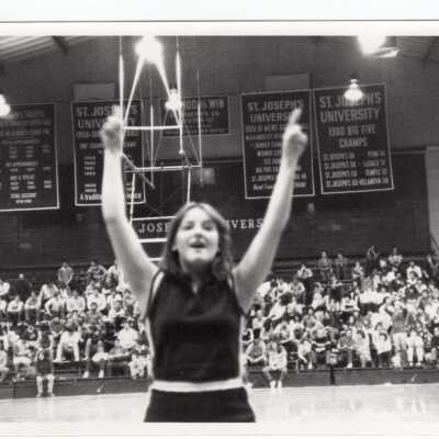 Woman cheerleader at basketball game.