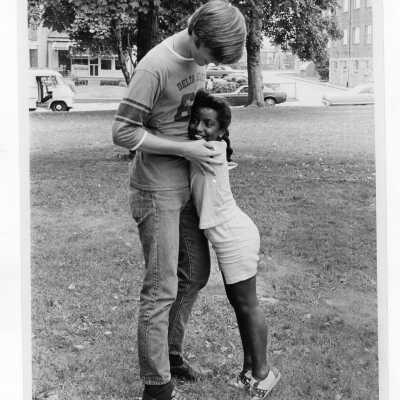 Student with child on playground as part of Mississippi summer project, a community service/outreach program (?)