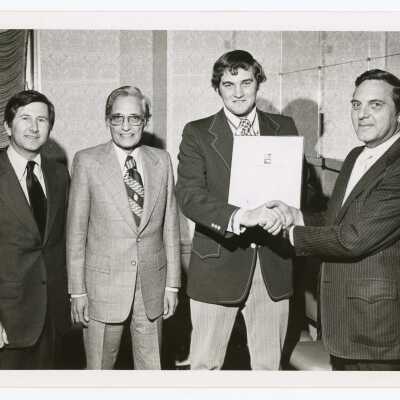 Leonard J. Barol, instructor for SJC course, "Packaging to Sell," held on December 11, 1973. Also pictured are student Charles E. Hopkins, and Norman T. Baldwin of the National Paper Box Association.