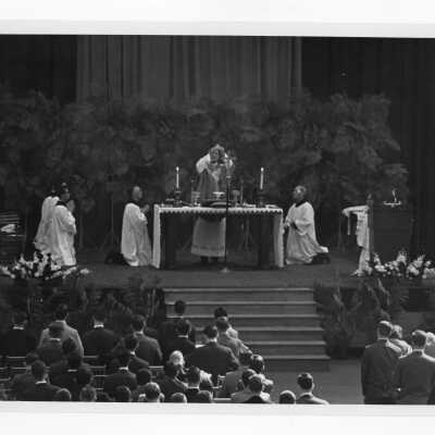 William F. Maloney, S.J., and others during Mass of the Holy Spirit in Field House, c. 1962.