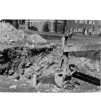 Bulldozer breaking ground for construction site of Drexel Library.